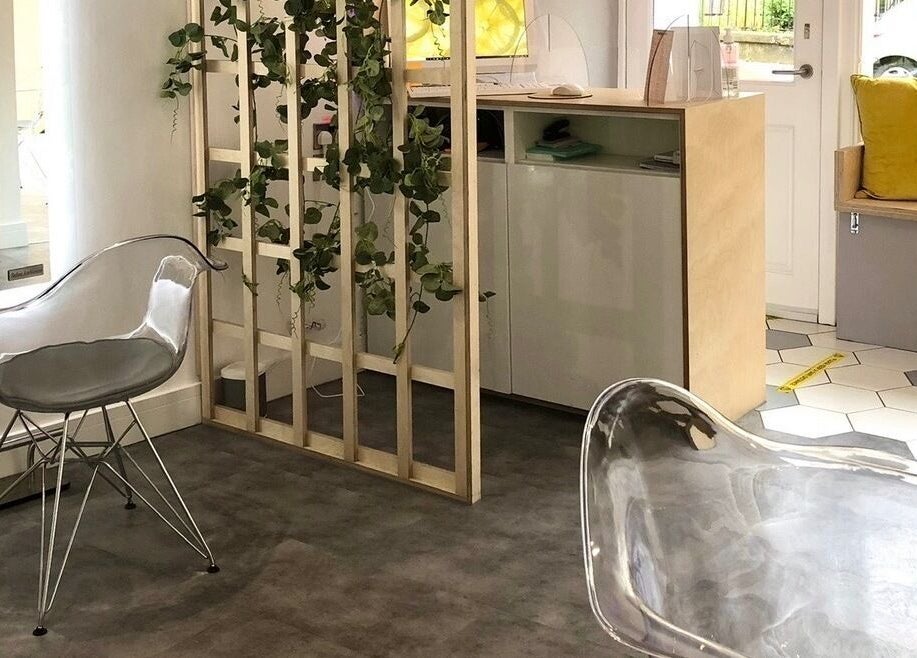Contemporary interior at Citrus Hair Bar, Edinburgh, Scotland, GB, featuring chic transparent chairs and greenery.