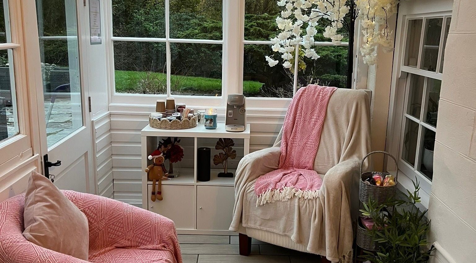 Inviting seating area at Kris's Nails, Washaway, England, GB, with plush pink chairs and elegant decor.