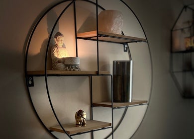 Elegant Buddha statue with candles on a shelf at Moon 8 Holistics, Wickham, England, GB.