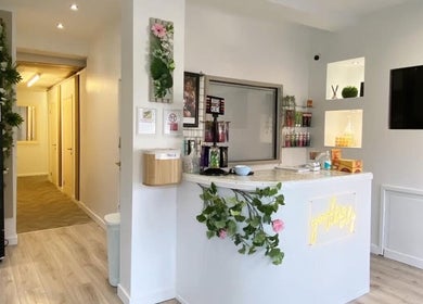 Reception area at Pure Aura Studio, Hindley Green, England, GB, with modern decor and elegant florals.
