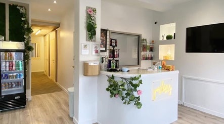 Reception area at Pure Aura Studio, Hindley Green, England, GB, with modern decor and elegant florals.