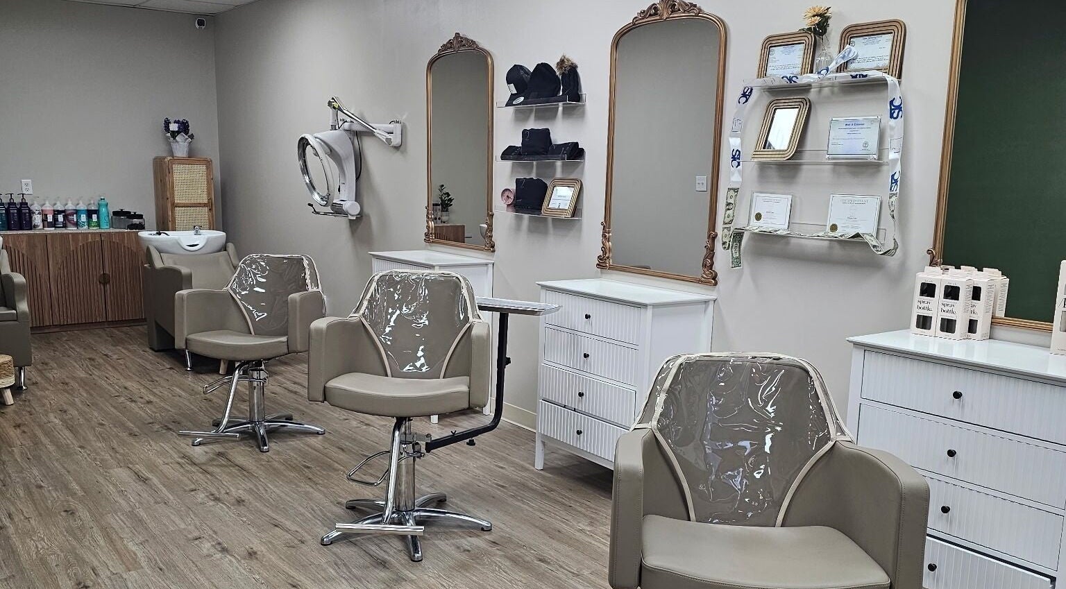 Modern salon interior at Hair by Faith, Munford, Tennessee, US, featuring chic styling stations and relaxing ambiance.
