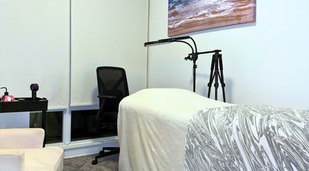 Cozy treatment room at Winked Studio, Toronto, Ontario, CA, featuring a comfortable massage table and serene decor.