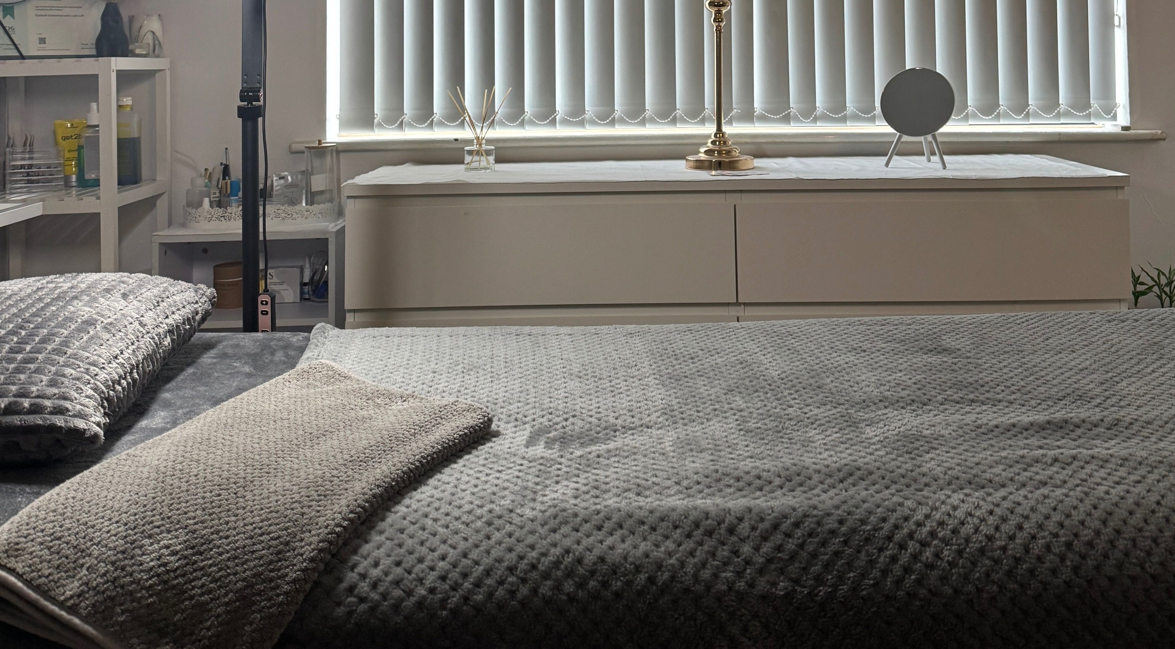 Cozy treatment room at Luminous Skin Clinic, Letterkenny, County Donegal, IE, with plush blankets and soft lighting.