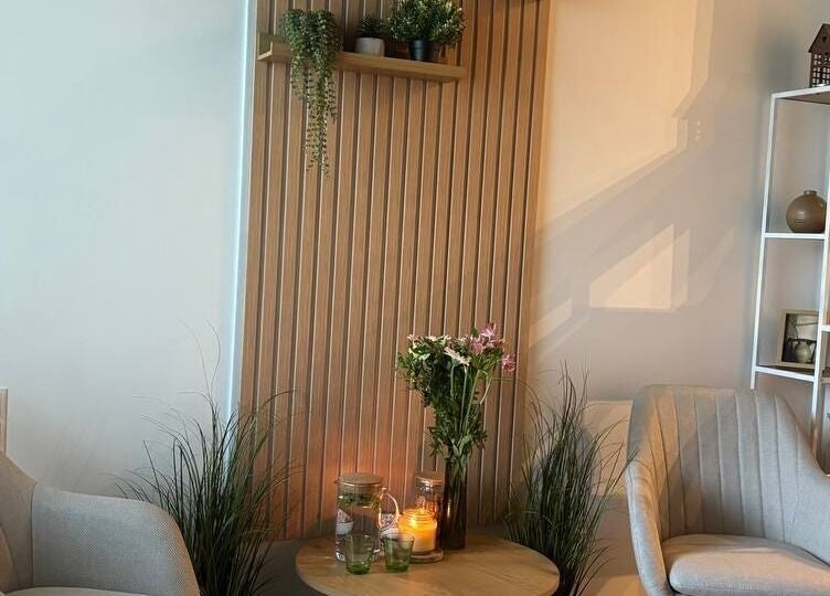 Cozy relaxation nook at Slow Beauty, Tallinn, Harju maakond, EE with chairs, candles, and plants.
