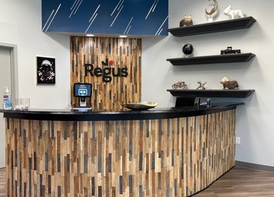 Reception area of MiTime Massage LLC, Fleming Island, Florida, US, with modern decor and wooden accents.