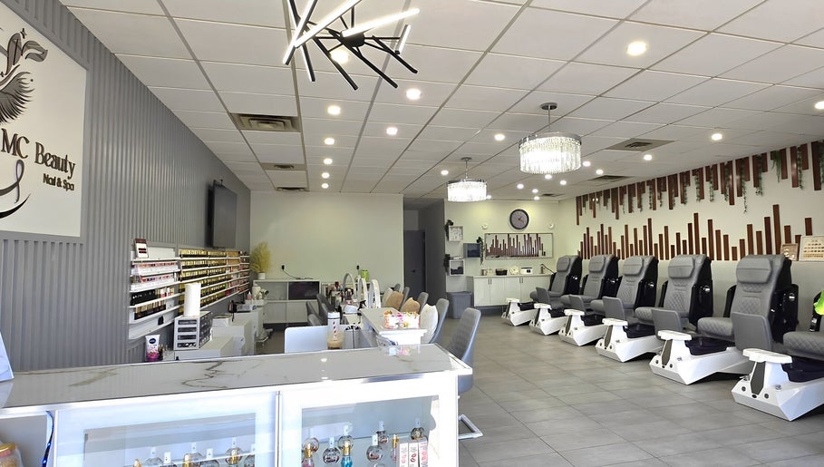Spacious interior of Mc Nails in Gibbons, Alberta, CA, showcasing modern nail stations and comfortable seating.