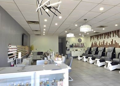 Spacious interior of Mc Nails in Gibbons, Alberta, CA, showcasing modern nail stations and comfortable seating.