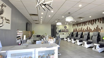 Spacious interior of Mc Nails in Gibbons, Alberta, CA, showcasing modern nail stations and comfortable seating.