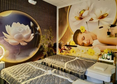 Luxurious spa room at Mc Nails in Gibbons, Alberta, CA, featuring tranquil lotus wall art and massage tables.