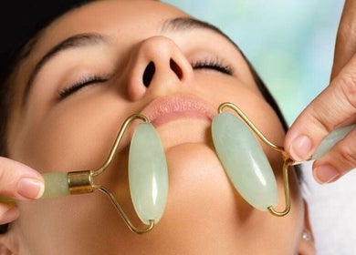Facial massage with jade roller at Mc Nails, Gibbons, Alberta, CA for rejuvenating skincare therapy.
