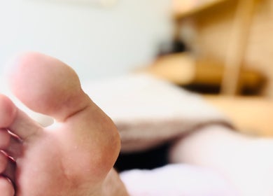 Close-up of foot during reflexology at Little Zen Reflexology, Bristol, England, GB.