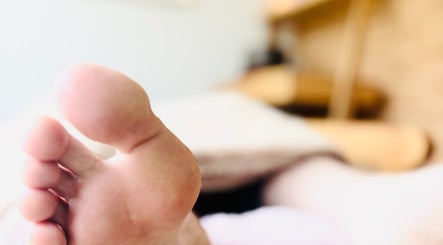 Close-up of foot during reflexology at Little Zen Reflexology, Bristol, England, GB.