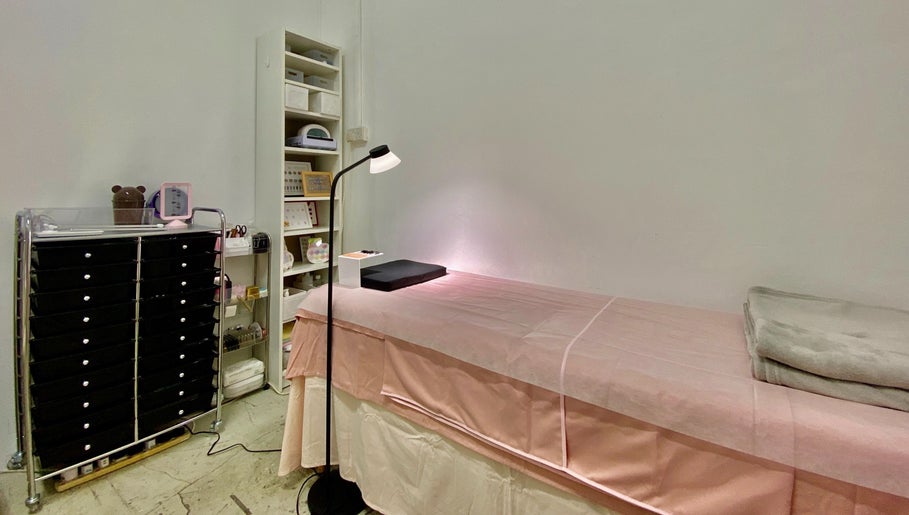 Calm treatment room at Je Chez Beau, Singapore, Singapore, SG with a cozy spa bed and organized shelves.