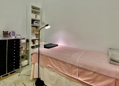 Calm treatment room at Je Chez Beau, Singapore, Singapore, SG with a cozy spa bed and organized shelves.