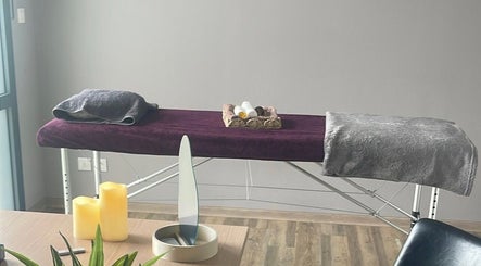 Table de massage à Mélody des Sens, Pont-sainte-marie, Grand Est, FR, entourée de bougies et de serviettes.