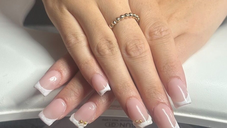 Beautiful French manicure with gold accents at Nailed.bymais, Grays, England, GB.