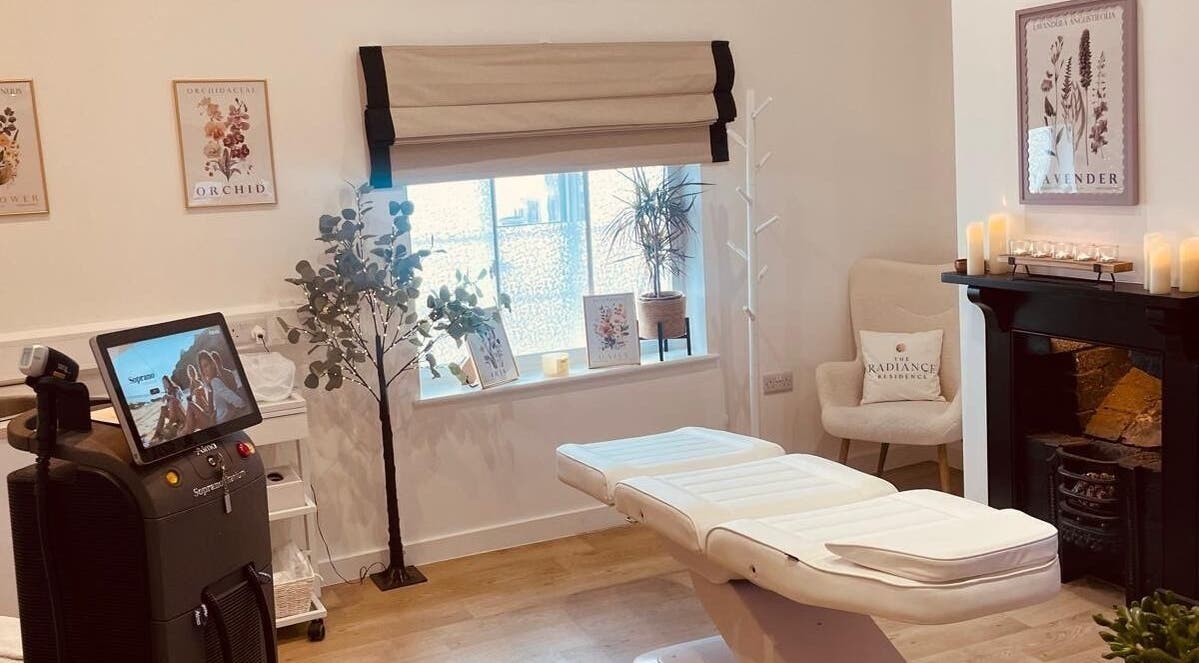Calm treatment room at Signature Aesthetics by Dr Gill, Lichfield, England, GB, with a massage table and decor.