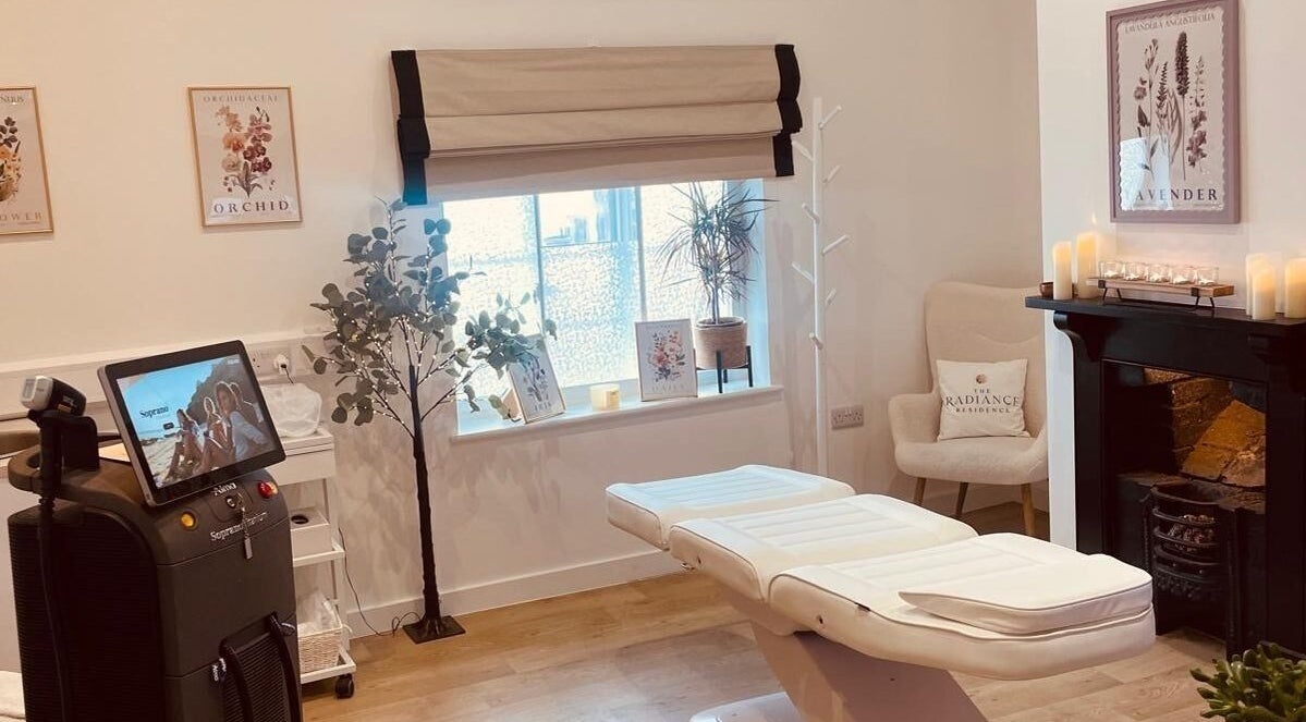 Calm treatment room at Signature Aesthetics by Dr Gill, Lichfield, England, GB, with a massage table and decor.