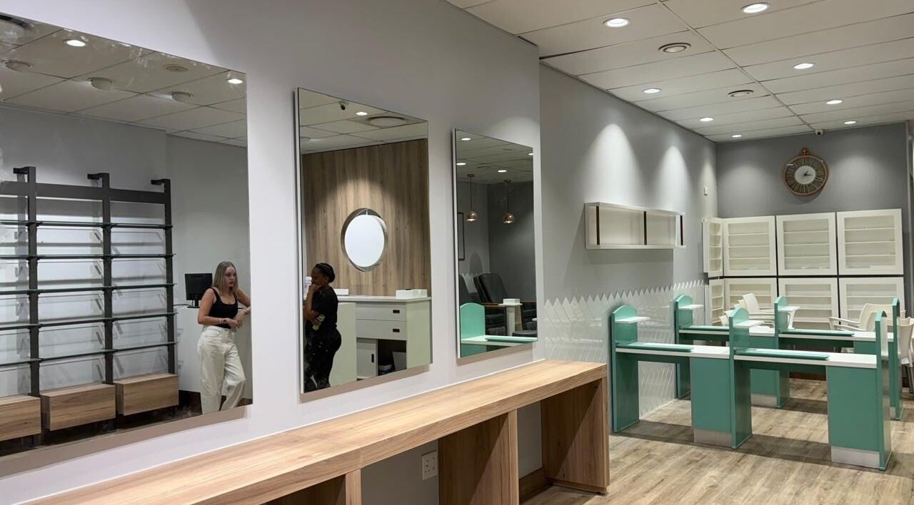 Elegant, modern interior of KG Lushious Hair Nails Salon in Sandton, Gauteng, ZA showcasing sleek design.