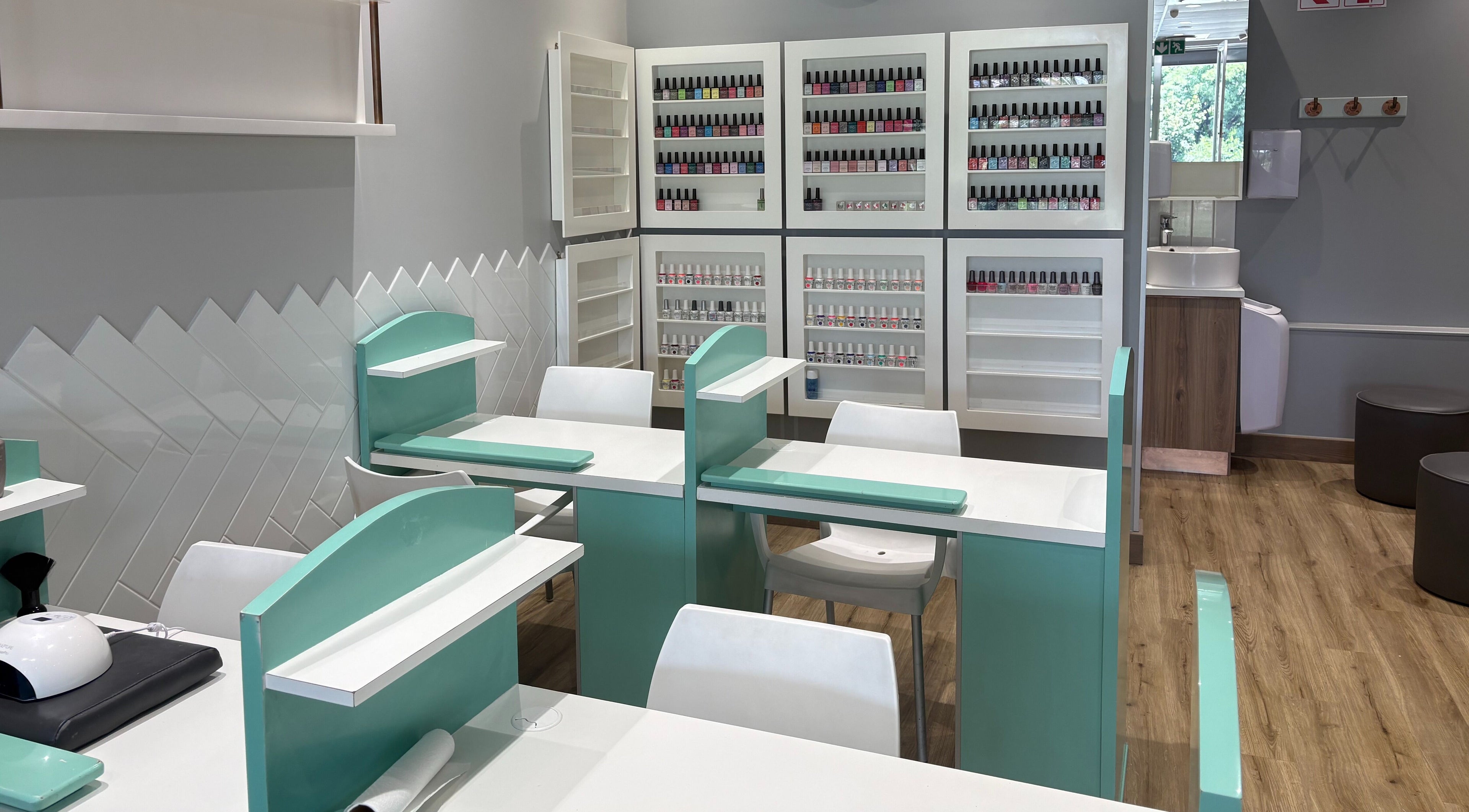 Elegant nail salon at KG Lushious in Sandton, Gauteng, ZA with rows of neatly displayed nail polishes.