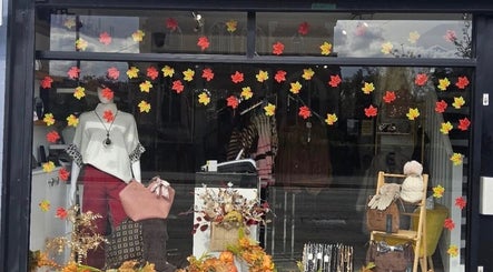 Autumn-themed window display at Kira Aesthetics, Coalville, England, GB showcasing fall fashion.