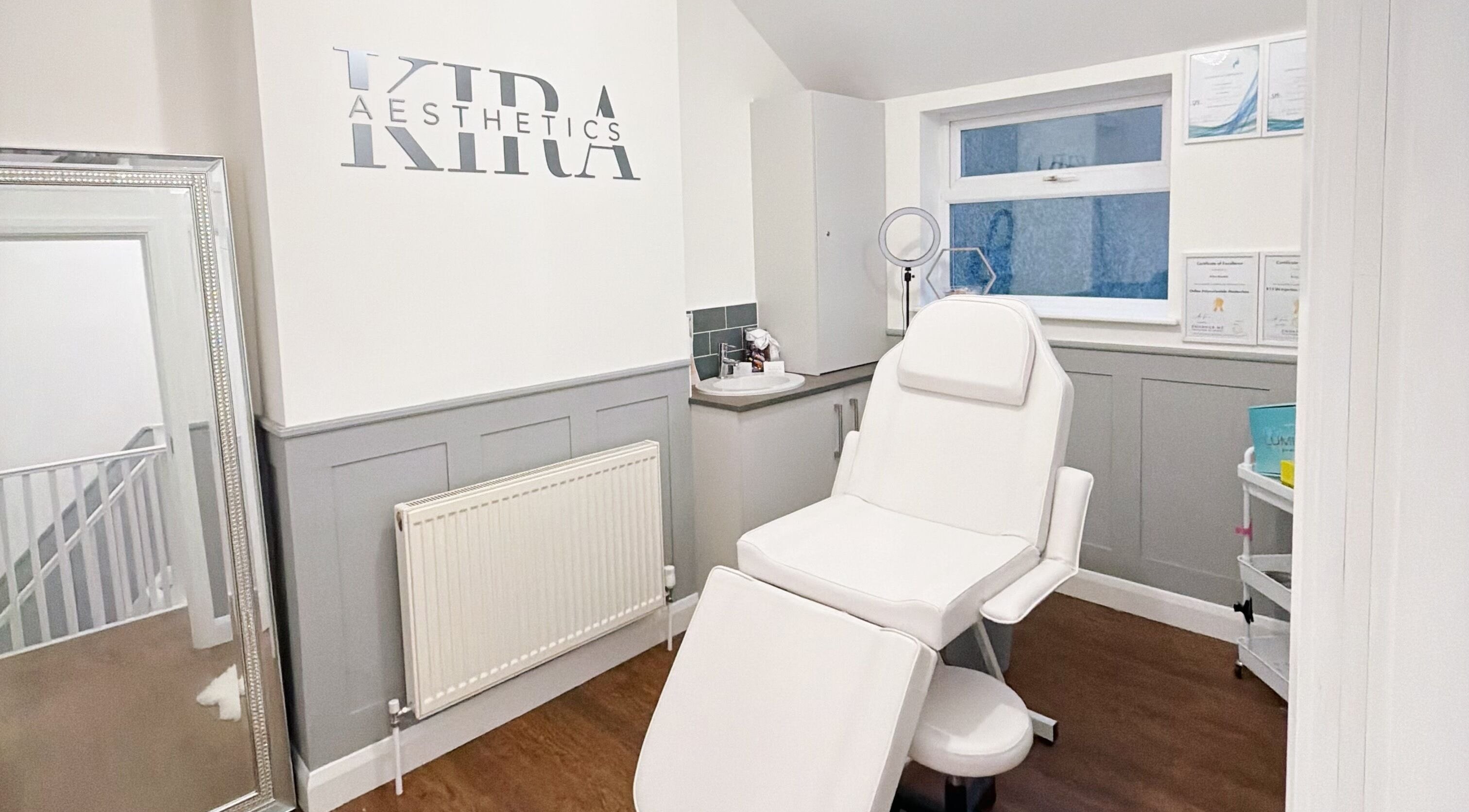 Tranquil treatment room at Kira Aesthetics in Coalville, England, GB featuring a white treatment chair.