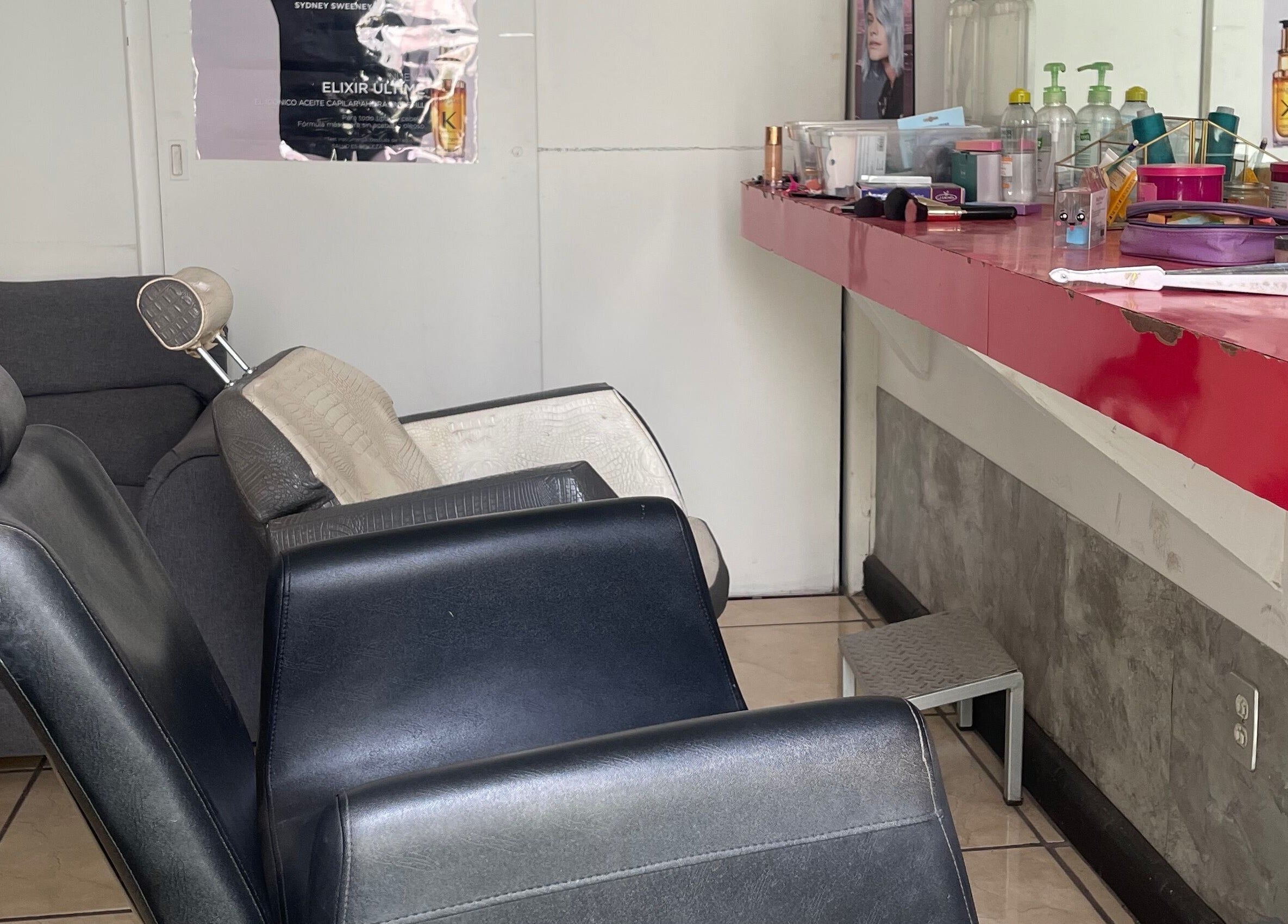 Interior de Jan Marzé en Durango, Durango, MX. Sillas de salón y mesa con productos de belleza.