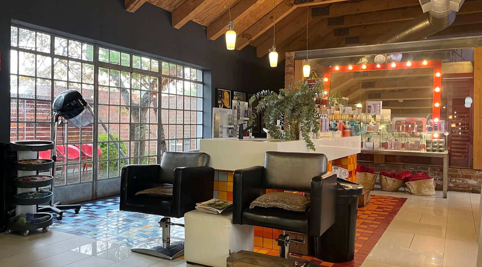 Kymric Hall beauty salon interior, featuring modern chairs and products, Franschhoek, Western Cape, ZA.