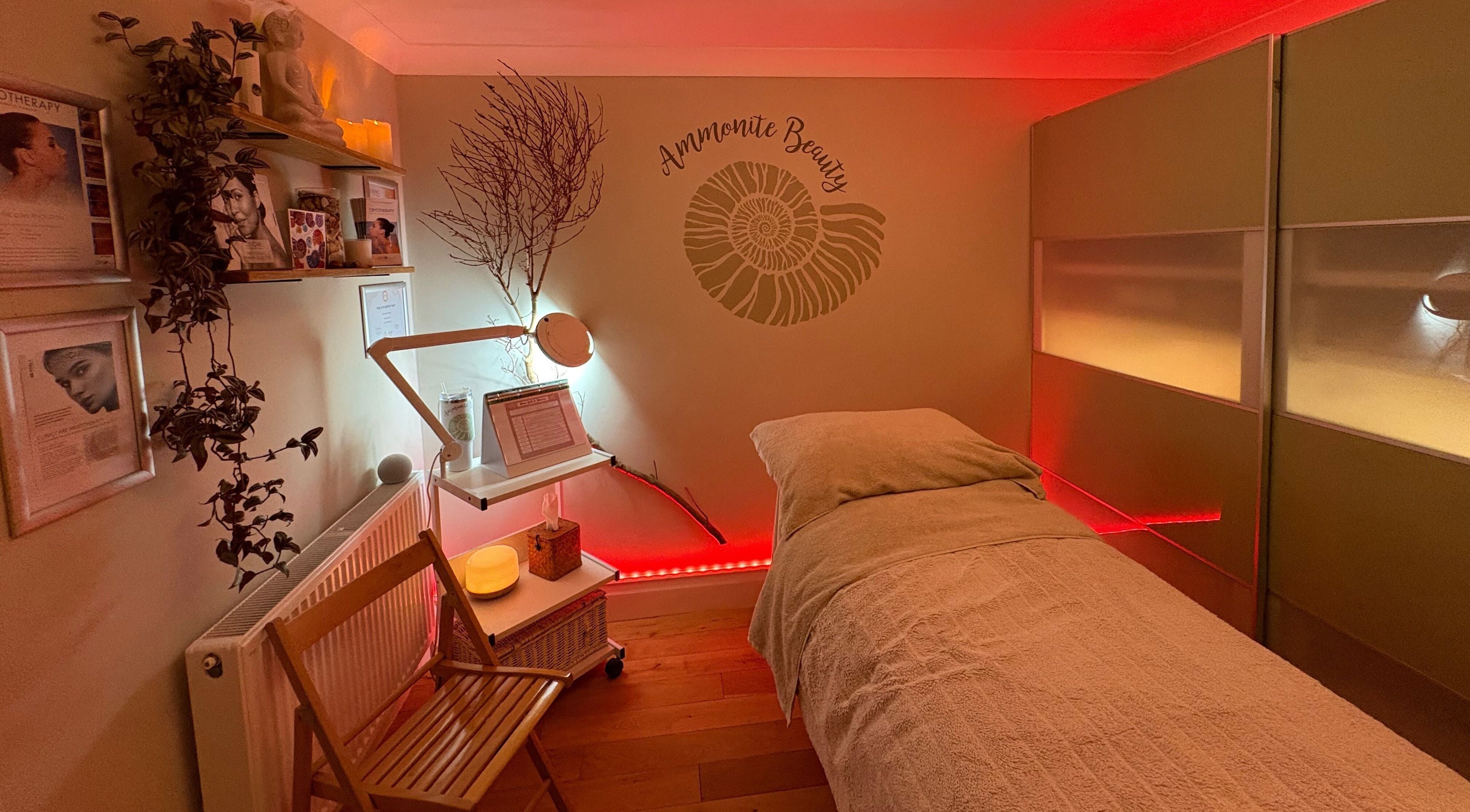 Relaxing treatment room at Ammonite Beauty in Bridport, England, GB, featuring soothing lighting and decor.
