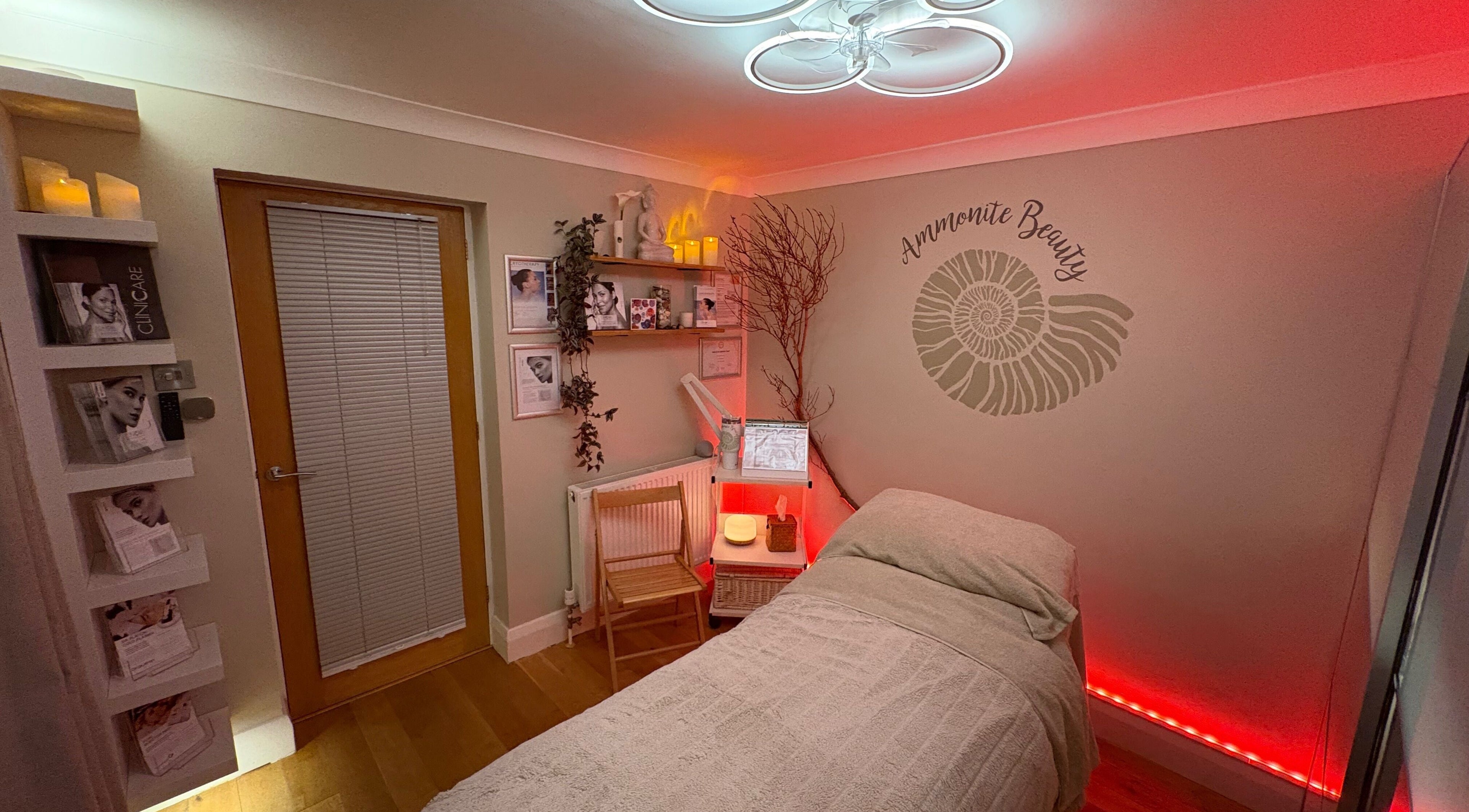 Cozy treatment room at Ammonite Beauty, Bridport, England, GB, with ambient lighting and calming decor.