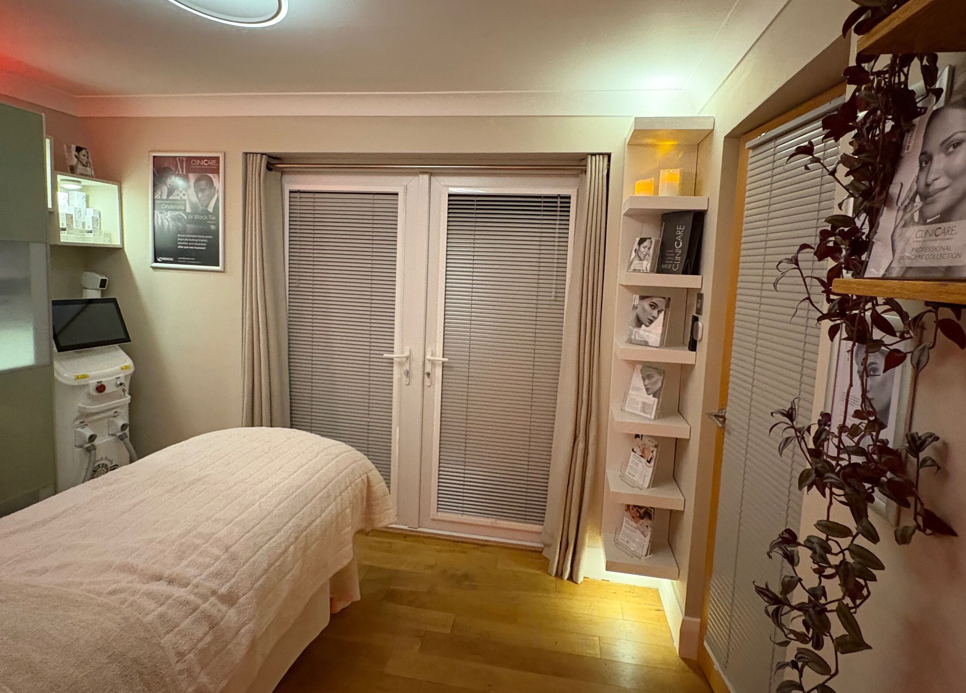 Tranquil spa room at Ammonite Beauty, Bridport, England, GB with treatment bed and soothing decor.