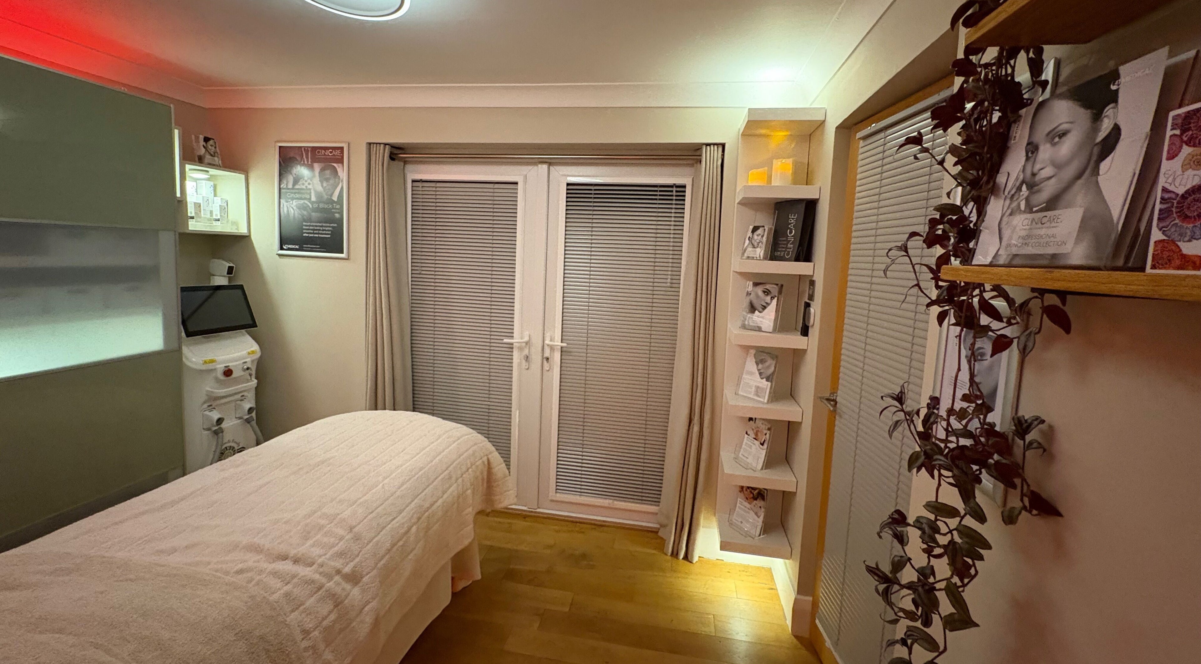 Tranquil spa room at Ammonite Beauty, Bridport, England, GB with treatment bed and soothing decor.