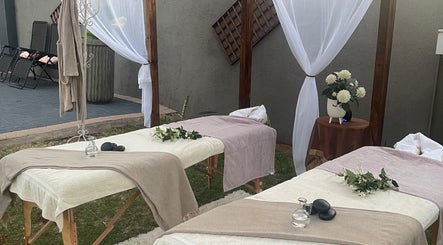Outdoor massage setup at Konanani Massage & Spa, Polokwane, Limpopo, ZA with elegant drapes and flowers.