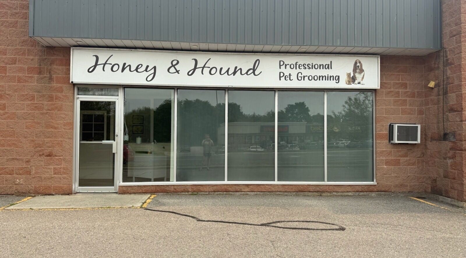 Exterior of Honey & Hound - Professional Pet Grooming in Cobourg, Ontario, CA, showcasing the storefront signage.