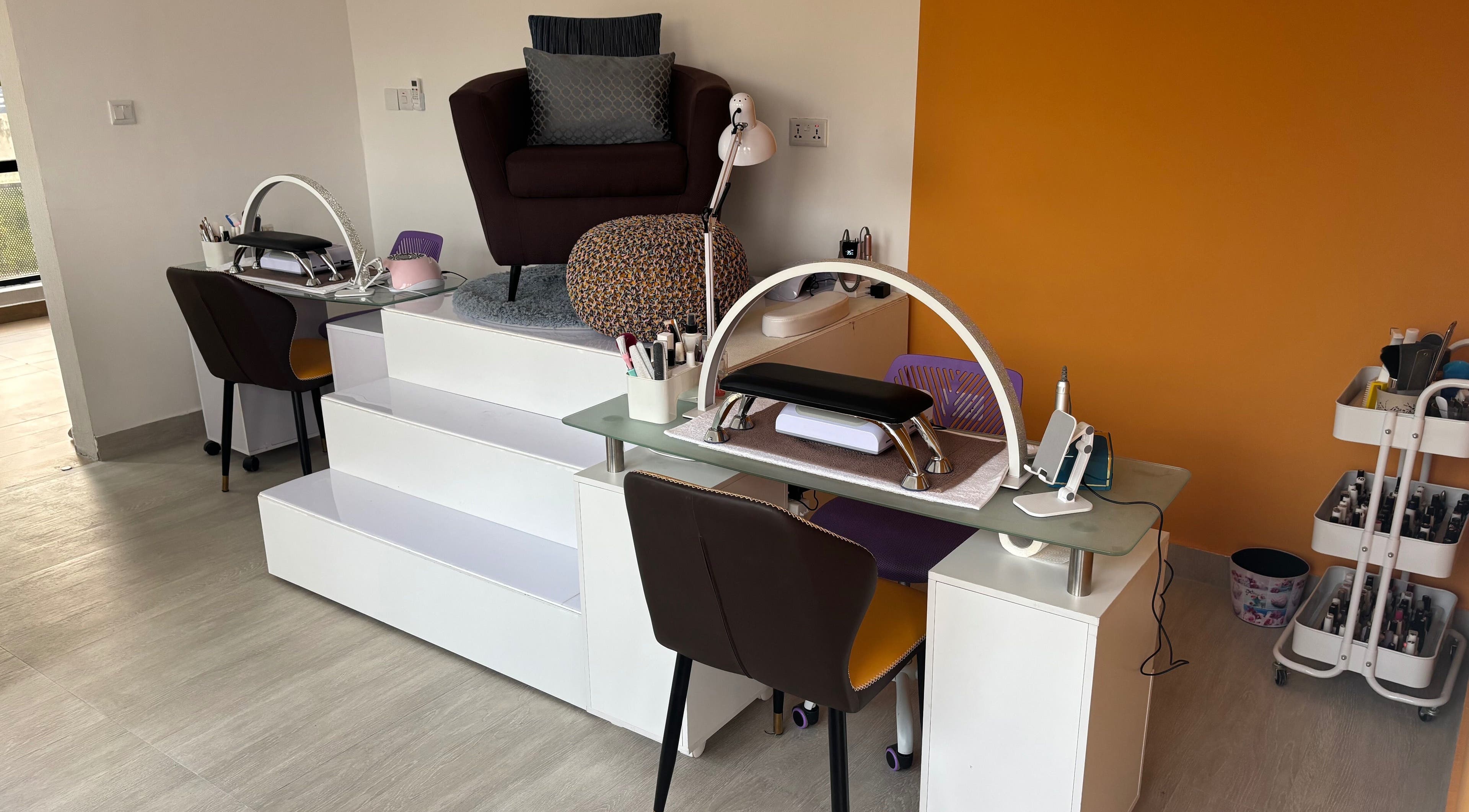 Nail care station at Body Language, Accra, Greater Accra Region, GH, featuring modern seating and tools.