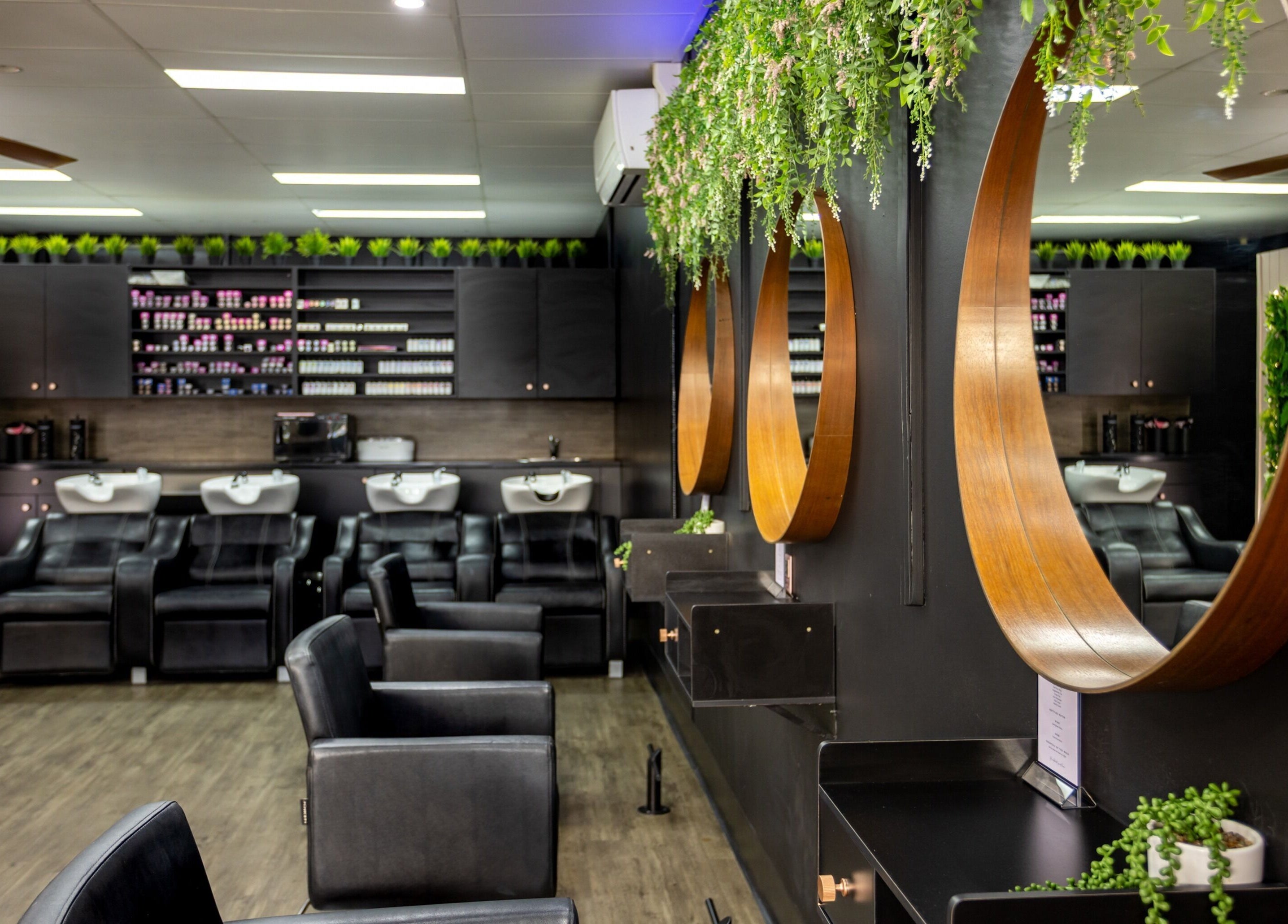 Modern salon interior at The Studio Hair & Tanning in Deception Bay, Queensland, AU, showcasing styling stations.