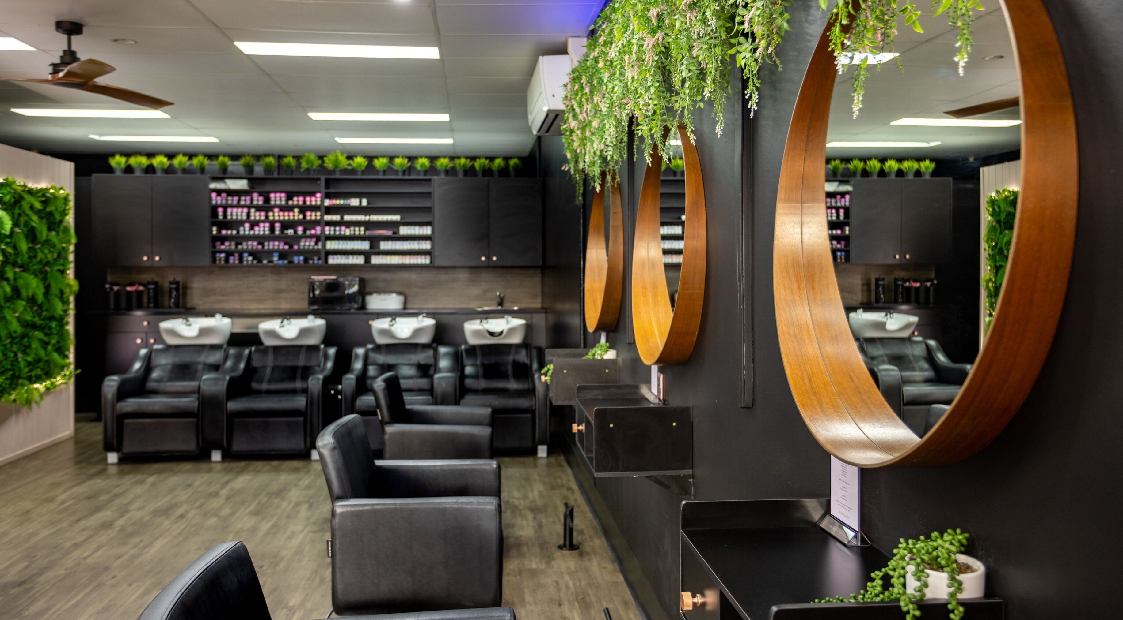 Modern salon interior at The Studio Hair & Tanning in Deception Bay, Queensland, AU, showcasing styling stations.