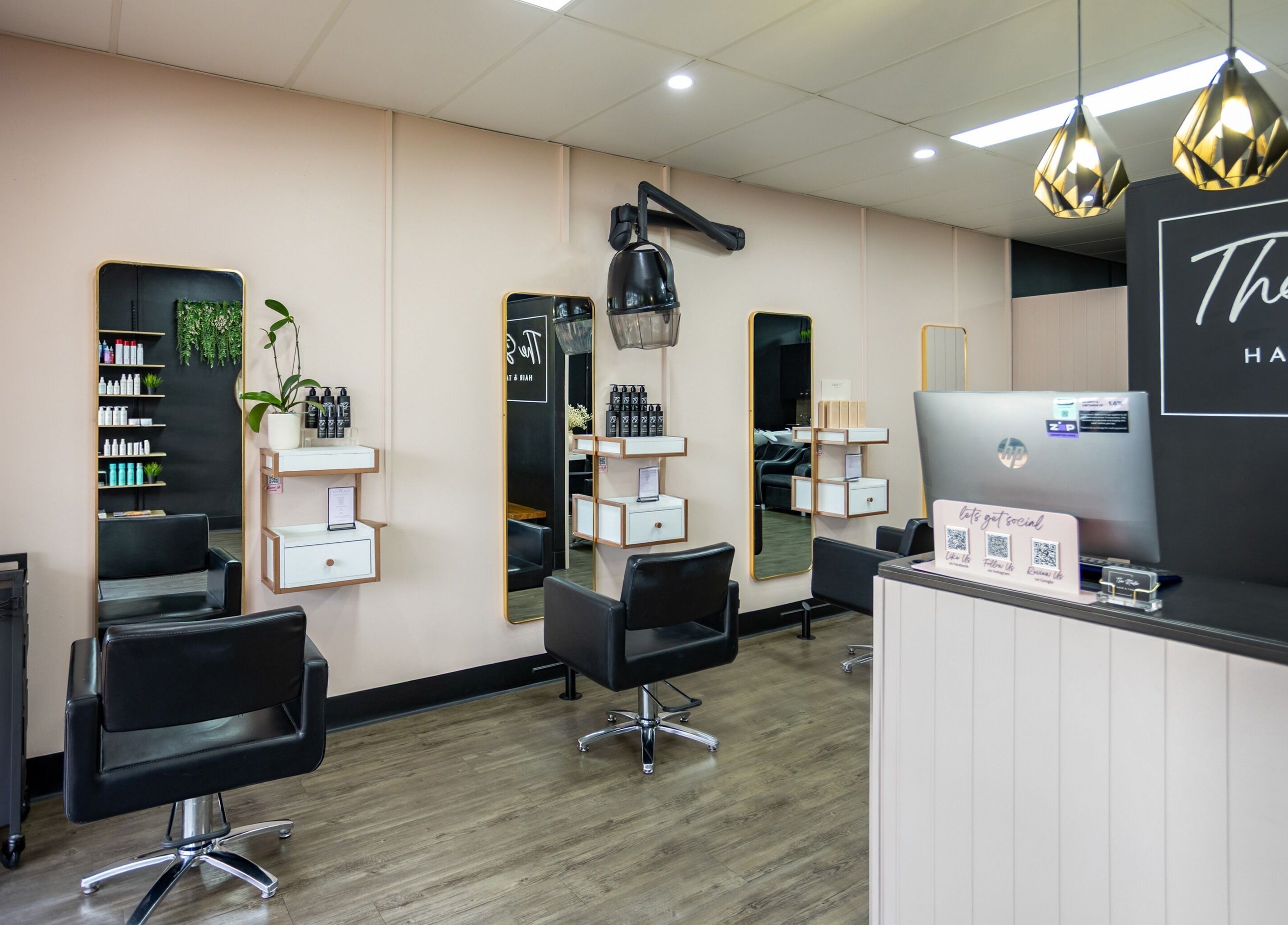 Modern salon interior at The Studio Hair & Tanning, Deception Bay, Queensland, AU, featuring sleek styling chairs.