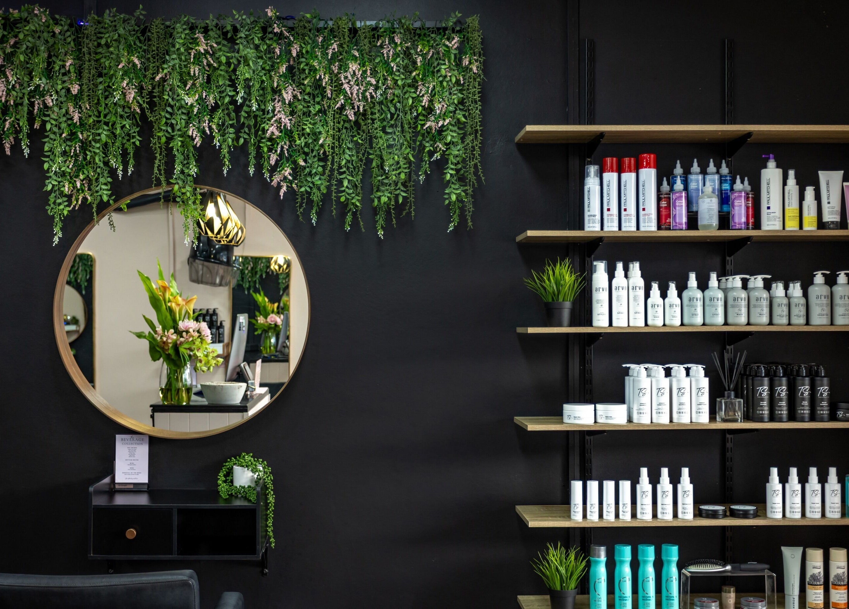Elegant interior of The Studio Hair & Tanning in Deception Bay, Queensland, AU with lush greenery and product display.