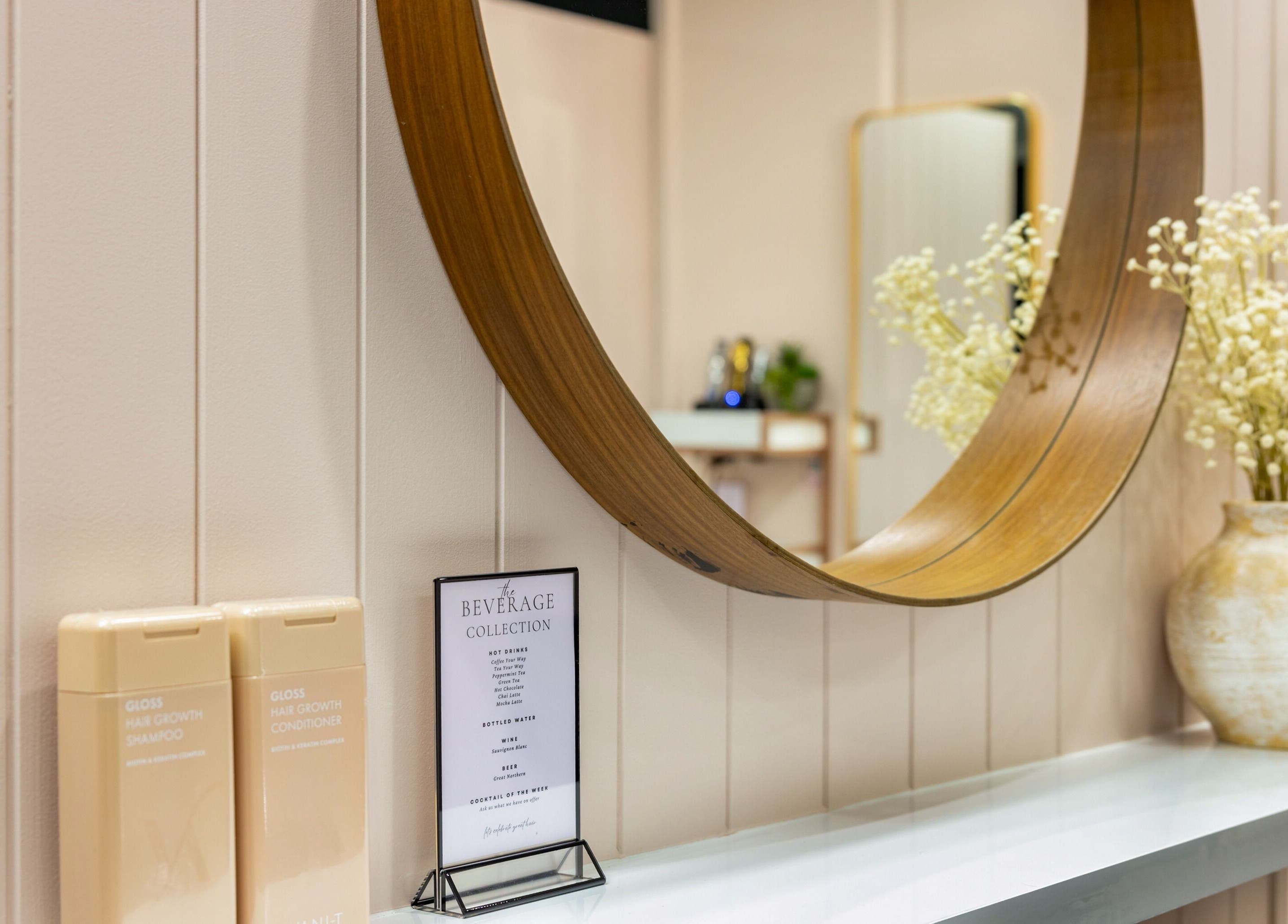 Stylish salon decor with a round mirror at The Studio Hair & Tanning, Deception Bay, Queensland, AU.