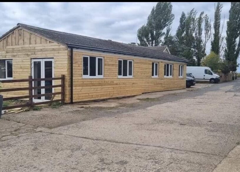 Wooden exterior of Confidence Beauty, Peterborough, England, GB, showcasing natural charm and approachable ambiance.