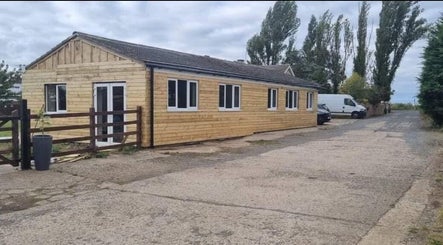 Wooden exterior of Confidence Beauty, Peterborough, England, GB, showcasing natural charm and approachable ambiance.