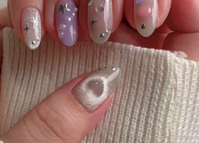 Elegant nail art showcased at Pro Nails Salon, Winnipeg, Manitoba, CA. Features sparkling, starry designs.
