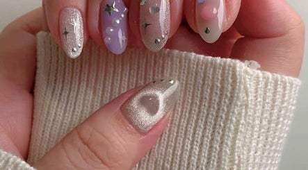 Elegant nail art showcased at Pro Nails Salon, Winnipeg, Manitoba, CA. Features sparkling, starry designs.