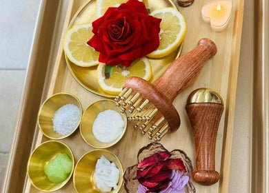 Luxurious spa tray at Pro Nails Salon, Winnipeg, Manitoba, CA with red rose, lemon slices, and massage tools.