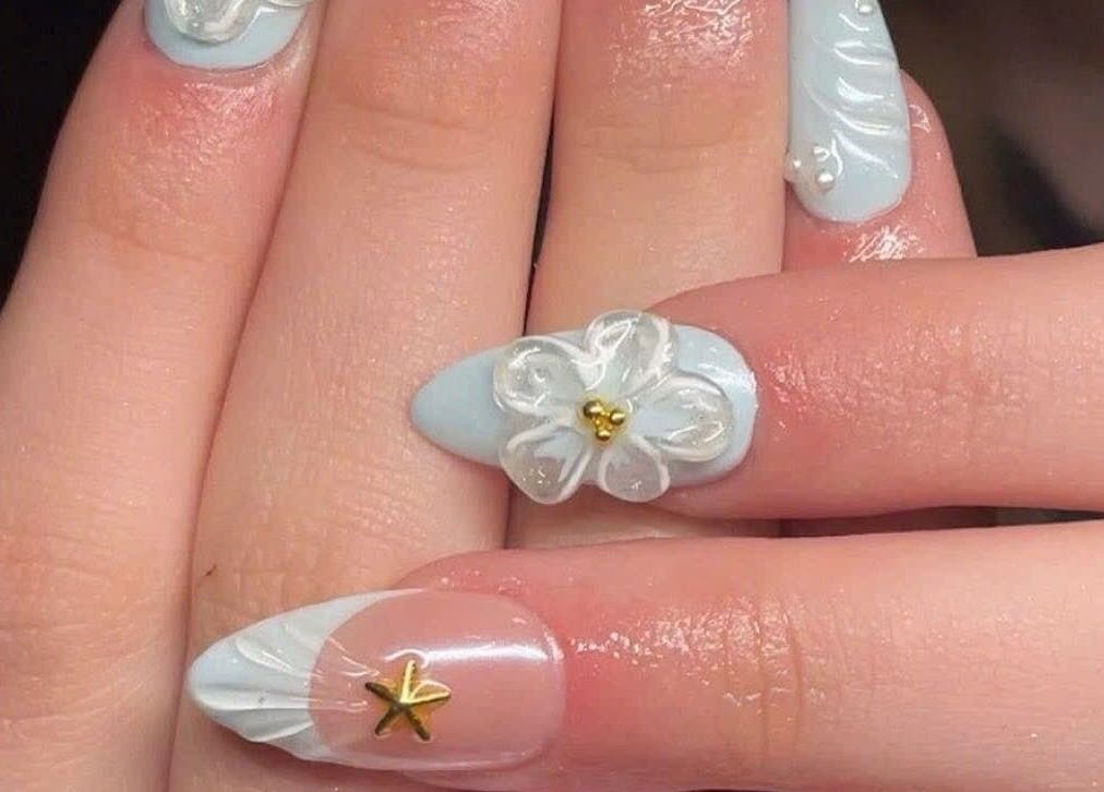 Elegant nail design with white flowers at Pro Nails Salon, Winnipeg, Manitoba, CA.