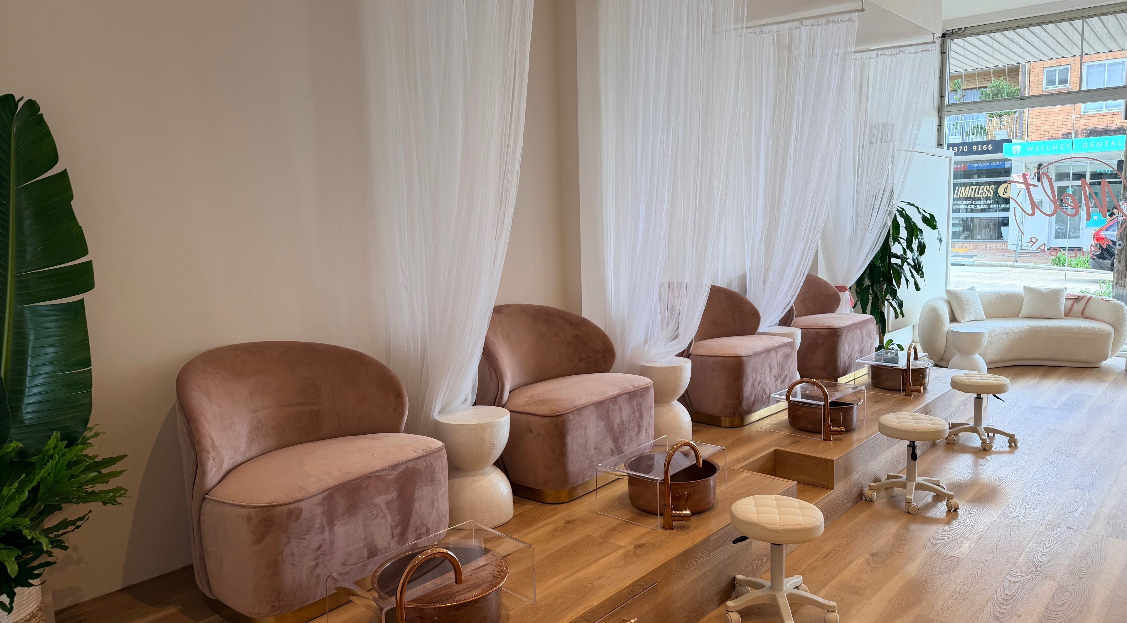Chic pedicure area at Melt Nail Bar, Bronte, New South Wales, AU with plush seating and sheer curtains.