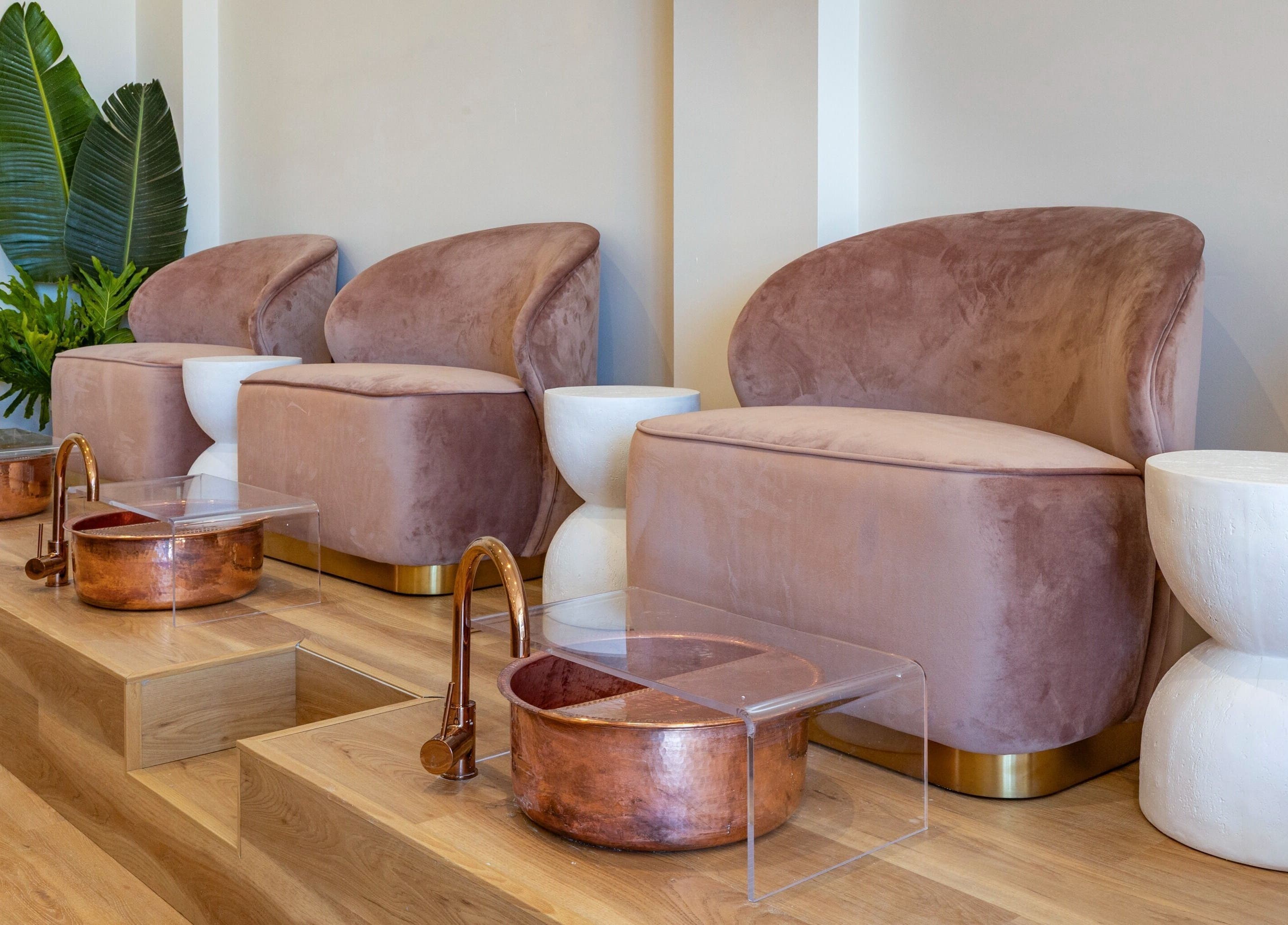 Luxurious pedicure stations at Melt Nail Bar in Bronte, New South Wales, AU with plush seating and copper basins.