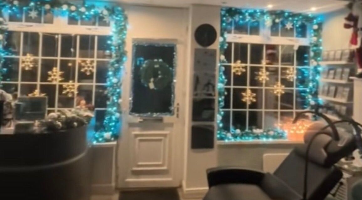 Festively decorated entrance of The Lash Studio NE in Jarrow, England, GB with holiday lights and snowflake motifs.